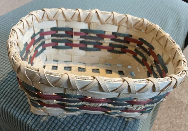 Handwoven plain-weave baskets with colored reed accents